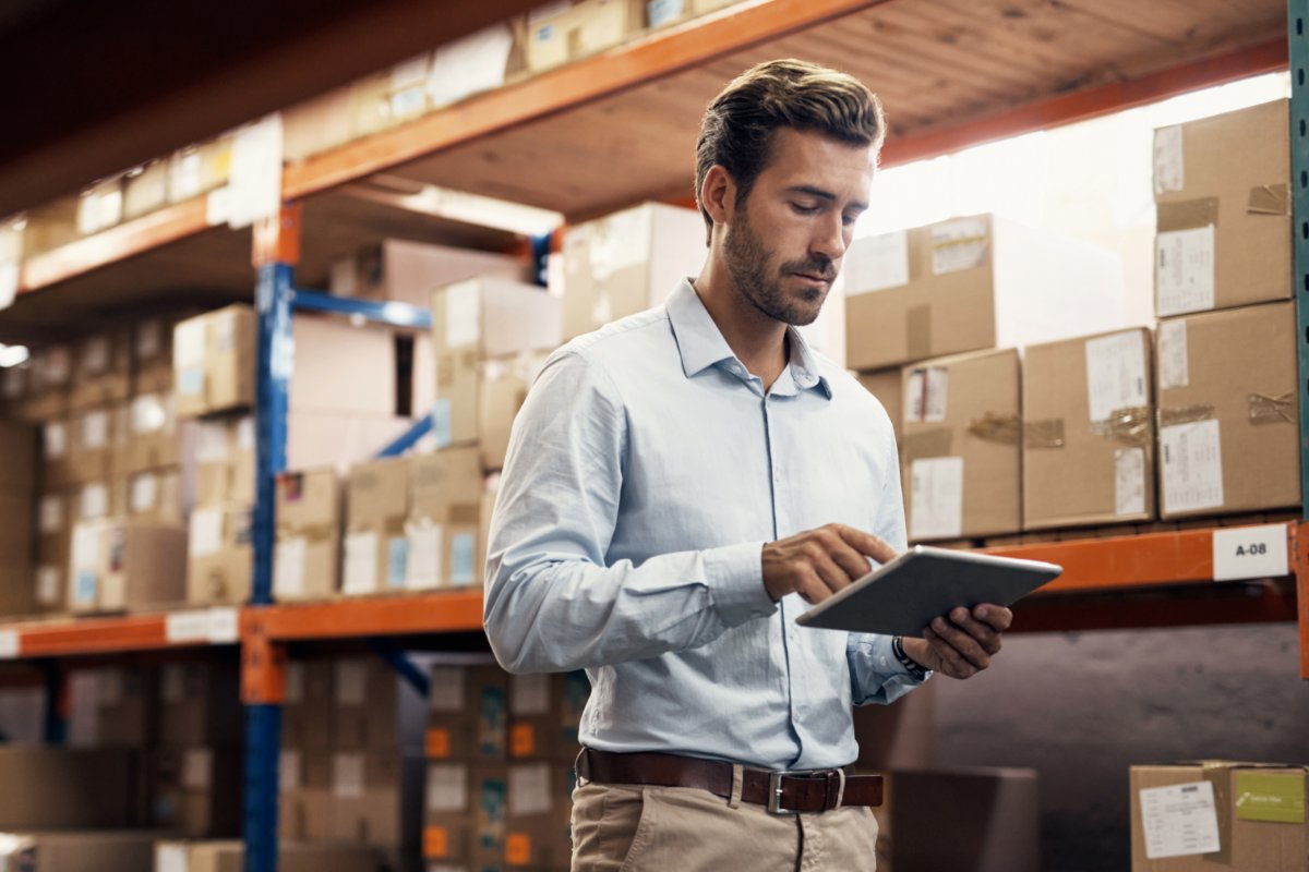 man in a warehouse counting inventory