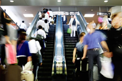 Photo of people in a mall on an escalator