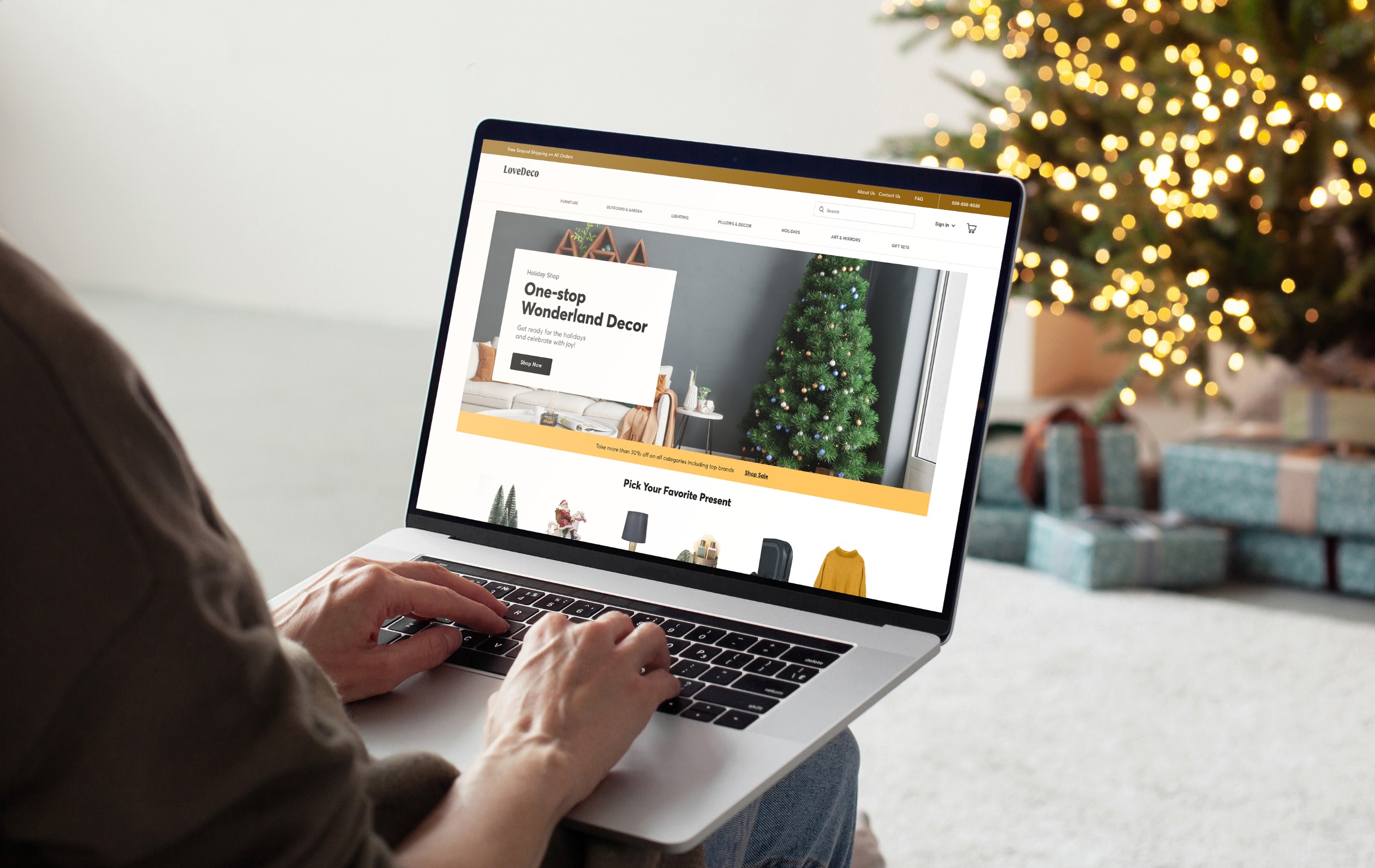 Photograph of a person sitting by a Christmas tree viewing an online store on their laptop